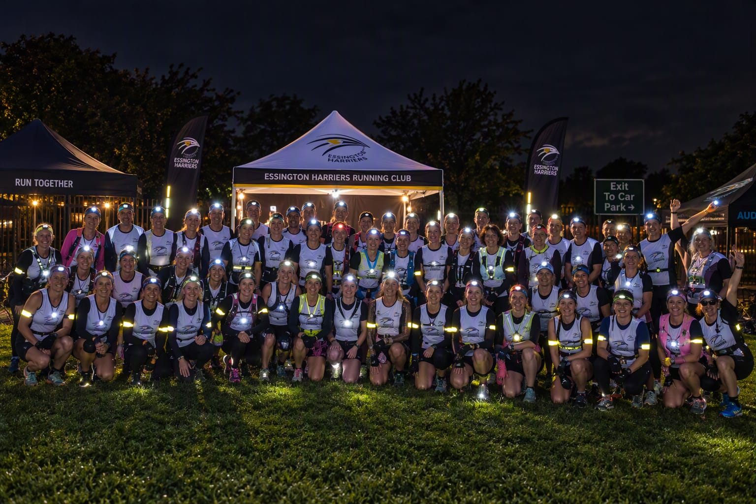 AI Group of mostly female runners in the dark.